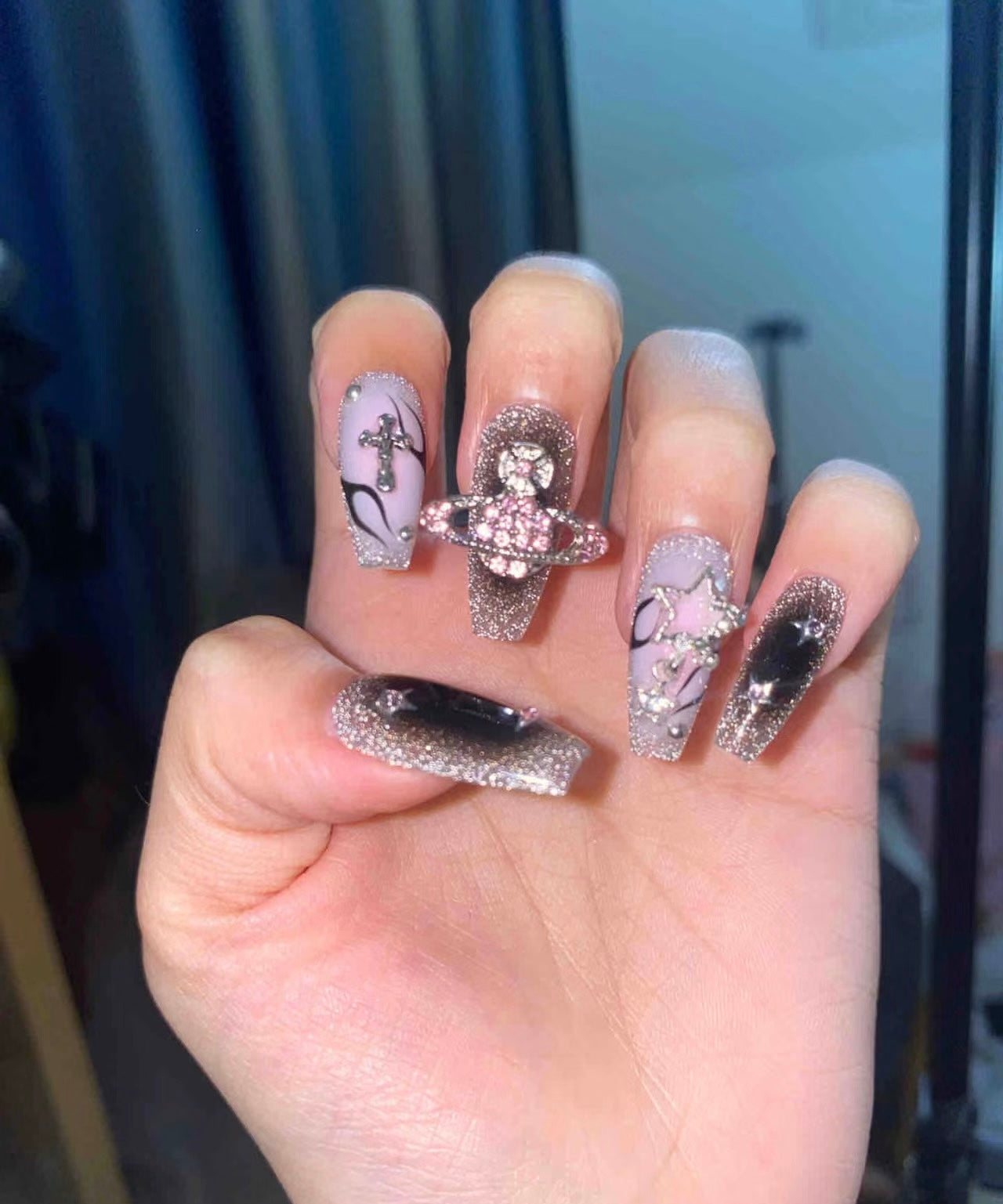 "Cosmic Elegance: Glittering Orbit & Star Nail Design"
