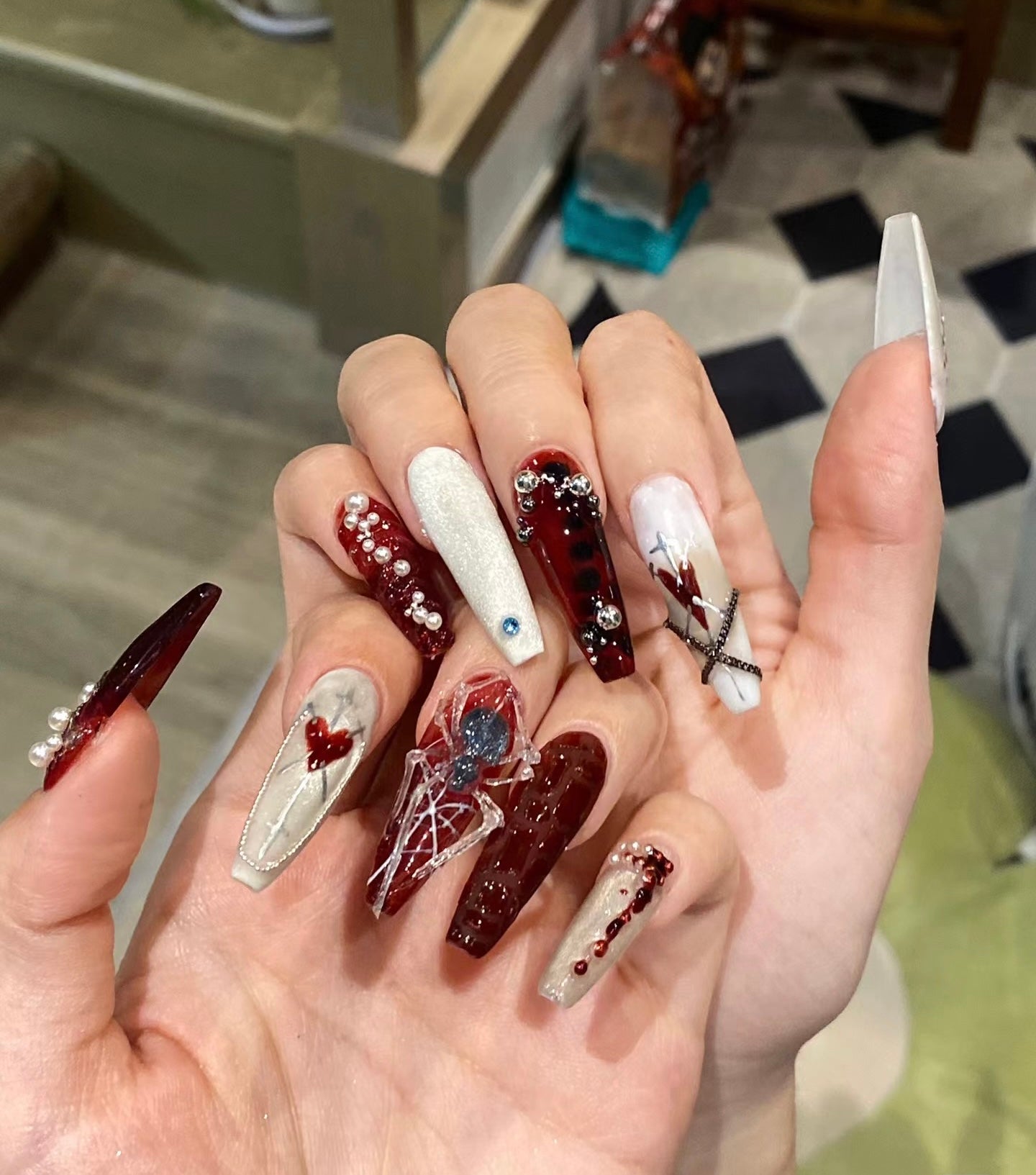 "Gothic Elegance: Dark Red and White Nail Art with 3D Embellishments"