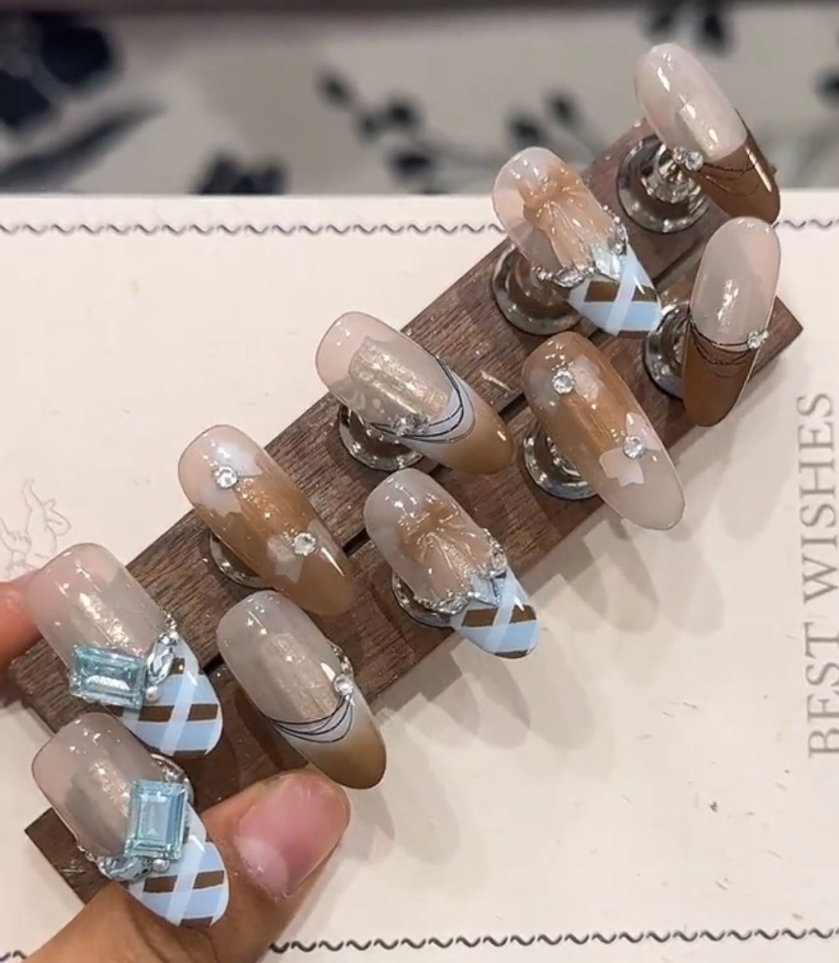 Blue and brown bow diamond nails