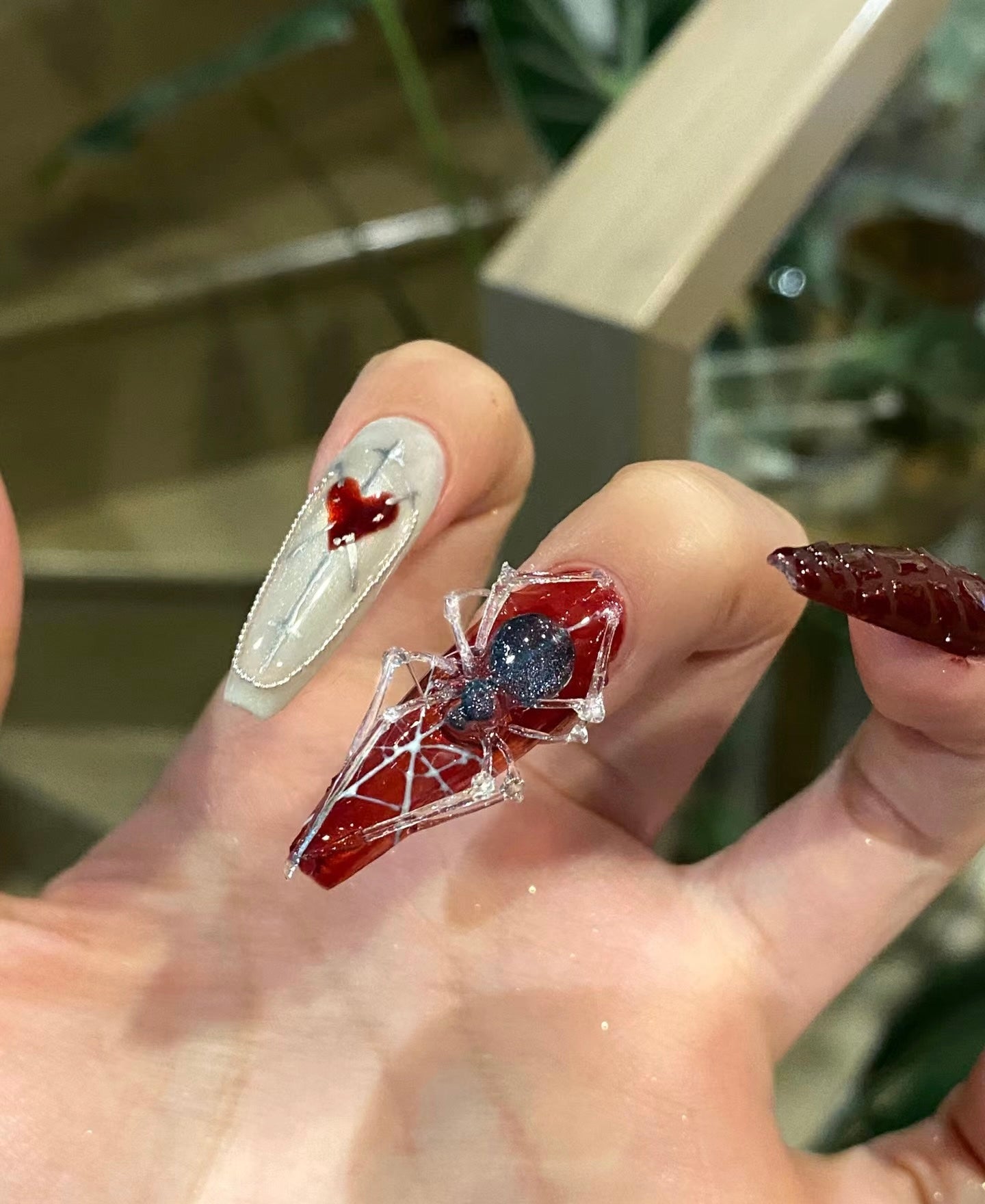 "Gothic Elegance: Dark Red and White Nail Art with 3D Embellishments"