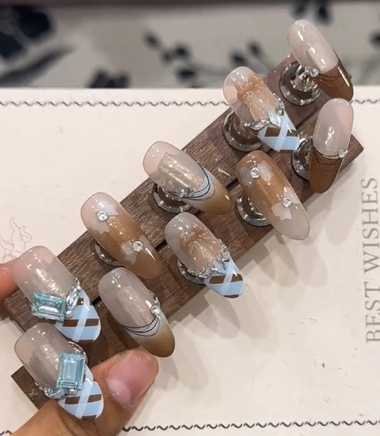 Blue and brown bow diamond nails