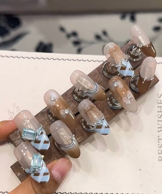 Blue and brown bow diamond nails
