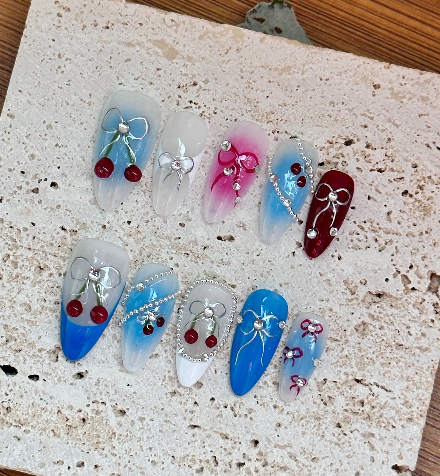 Cherry and Bow Nail Art Design with Gradient Blue and Pink Accents