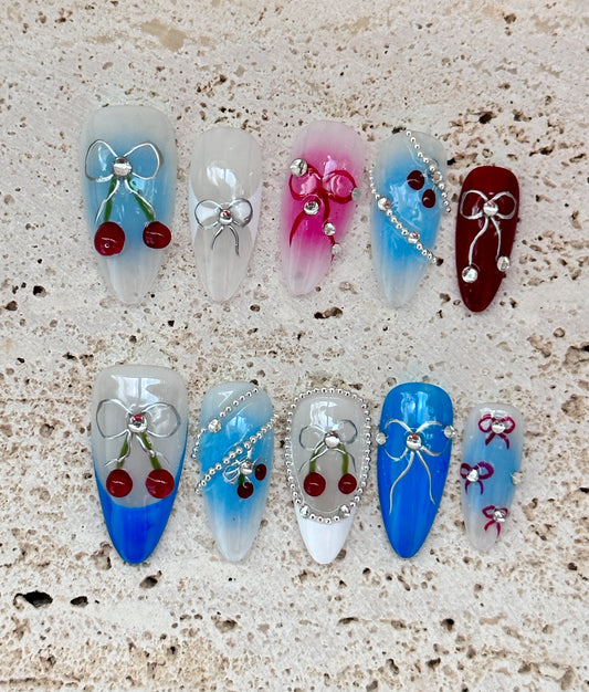 Cherry and Bow Nail Art Design with Gradient Blue and Pink Accents