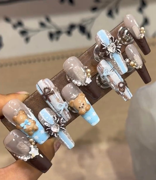 Brown bow melancholy bear nails