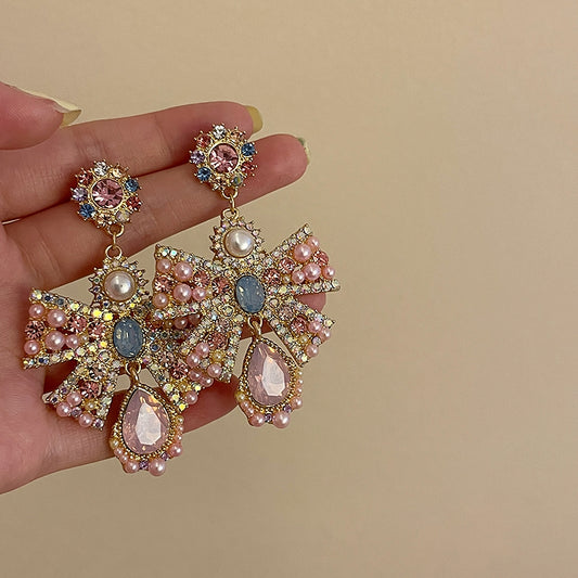 Pink exaggerated pearl bow earrings, unique design sense, light luxury earrings, evening dress earrings, female