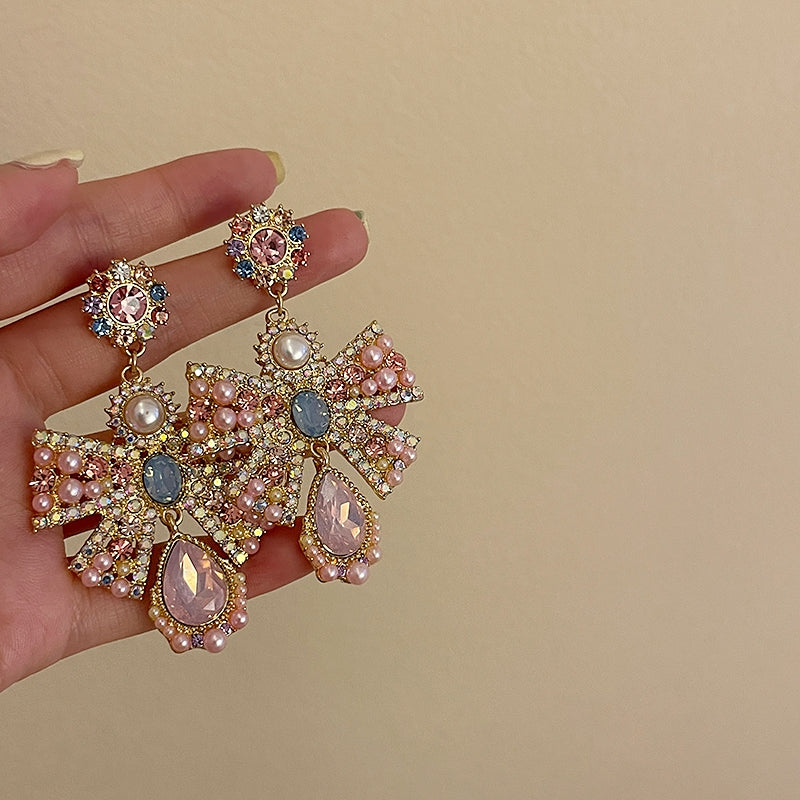 Pink exaggerated pearl bow earrings, unique design sense, light luxury earrings, evening dress earrings, female